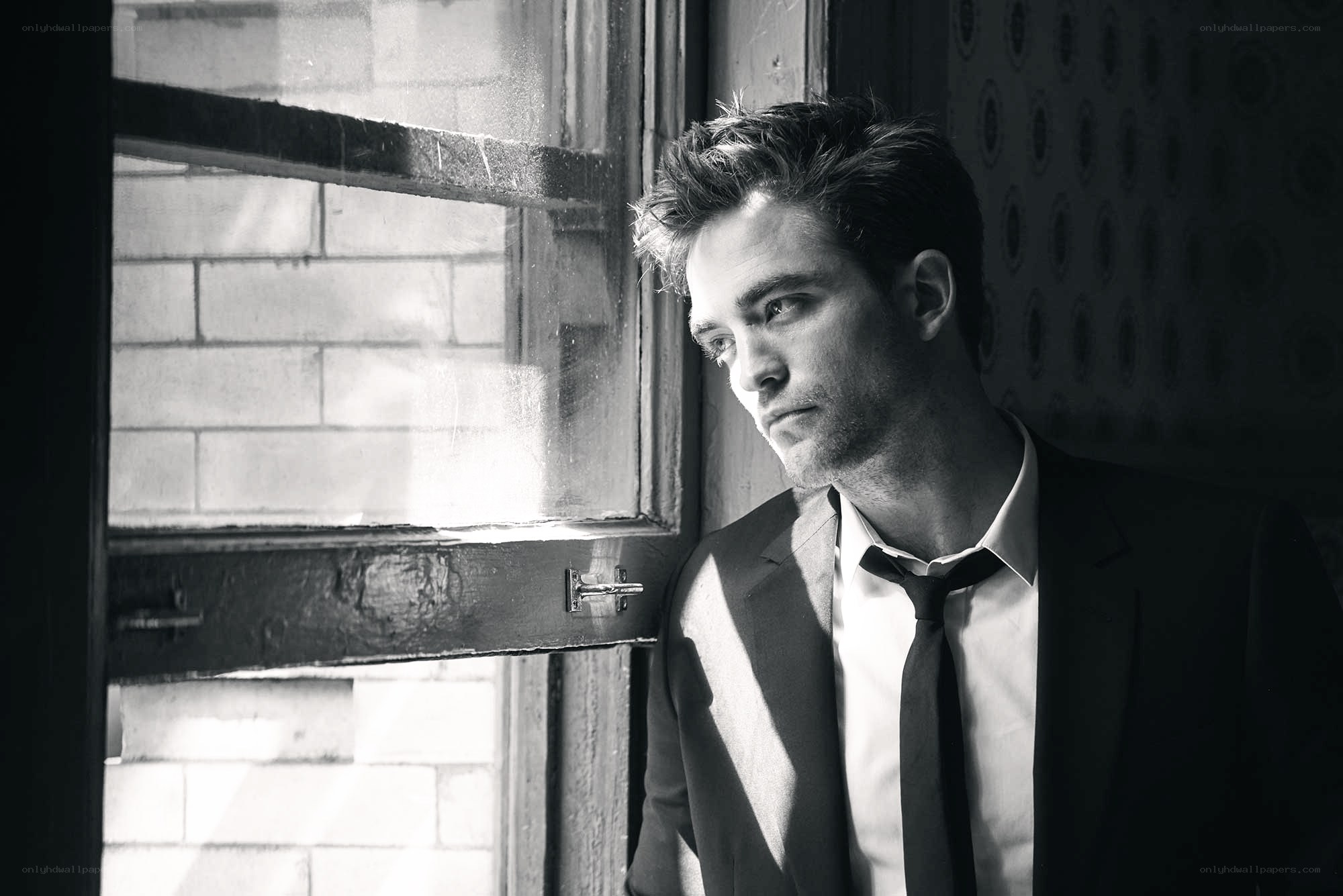 man in suit by window