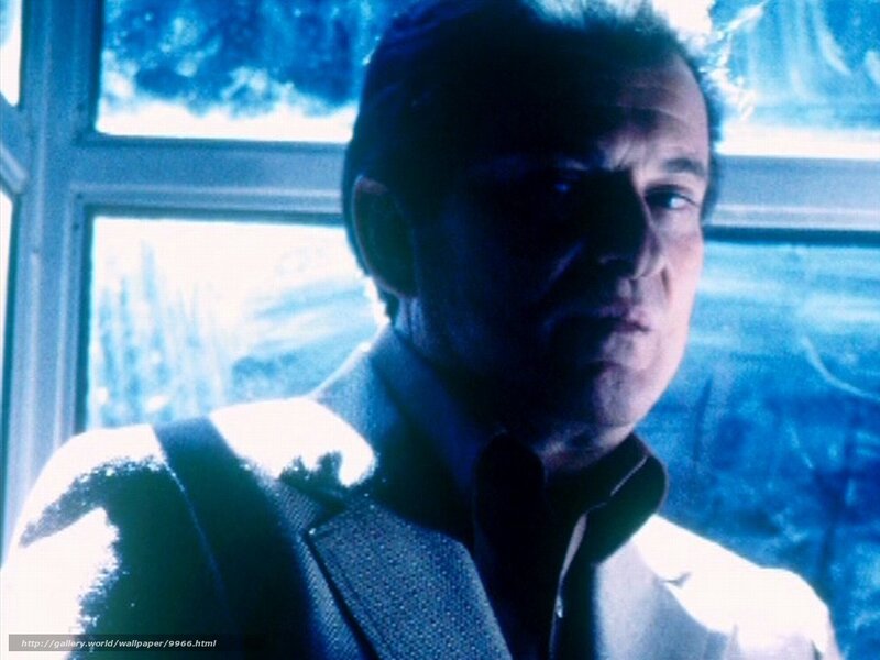 man in suit by window