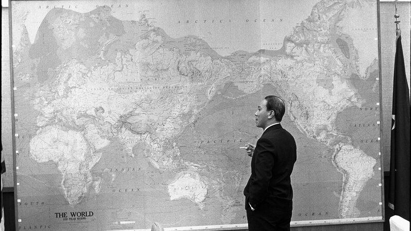 Man in suit by world map
