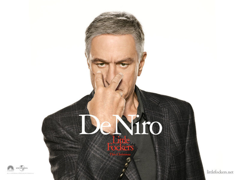 Man in Suit Covering Nose