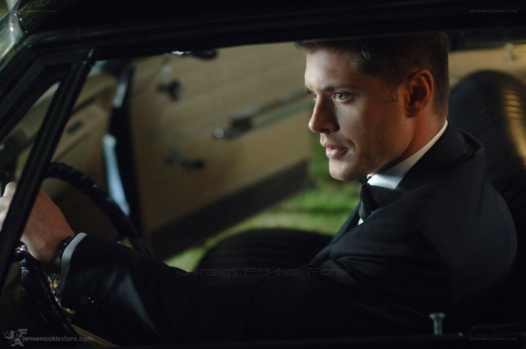 man in suit driving car