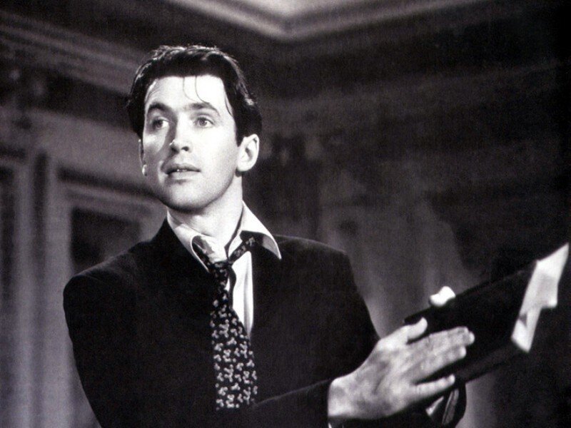 Man in Suit Holding Book
