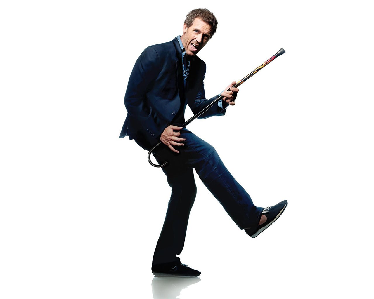 man in suit holding cane