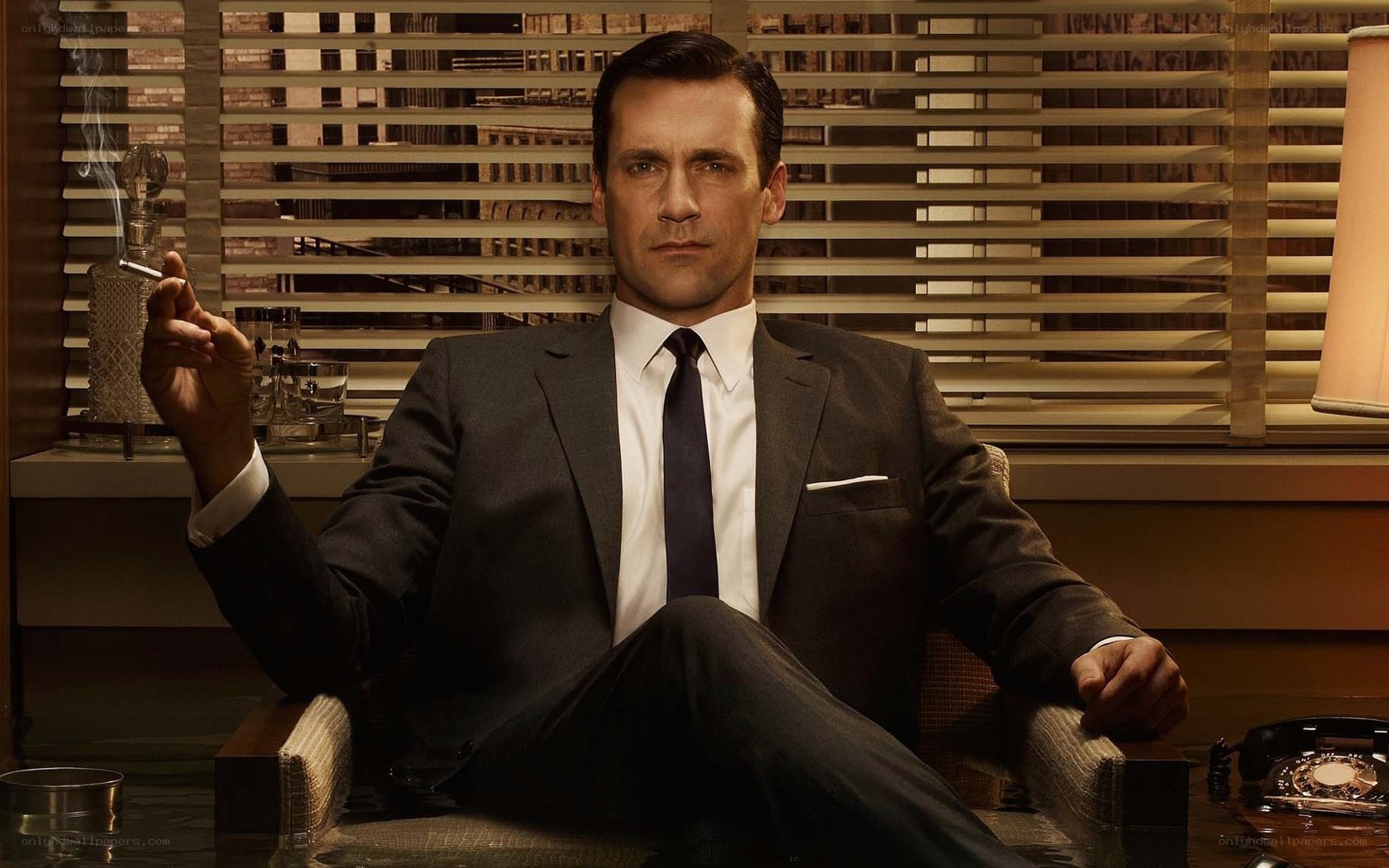 man in suit holding cigarette