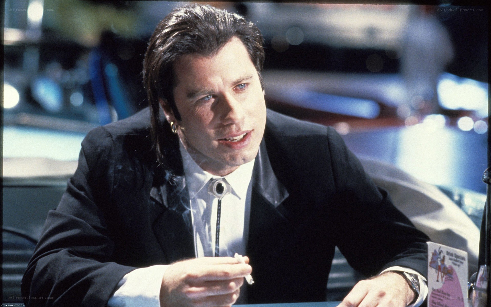 man in suit holding cigarette