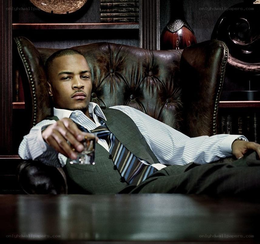 man in suit holding drink