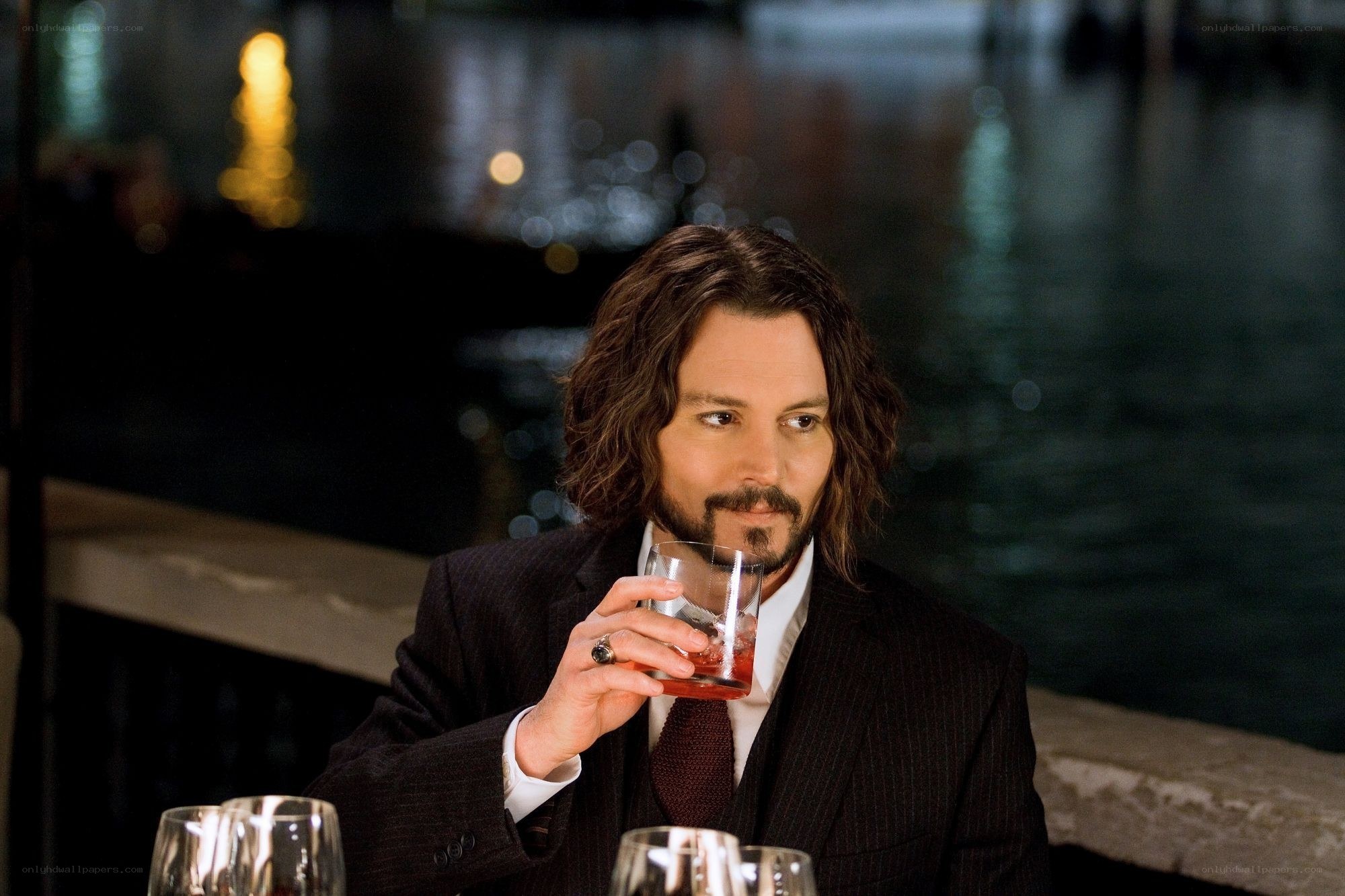 Man in suit holding drink