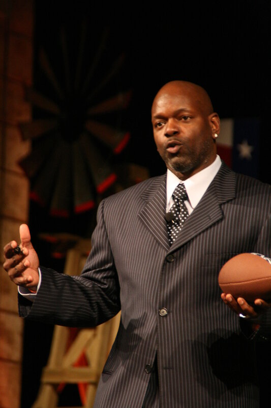 Man in suit holding football