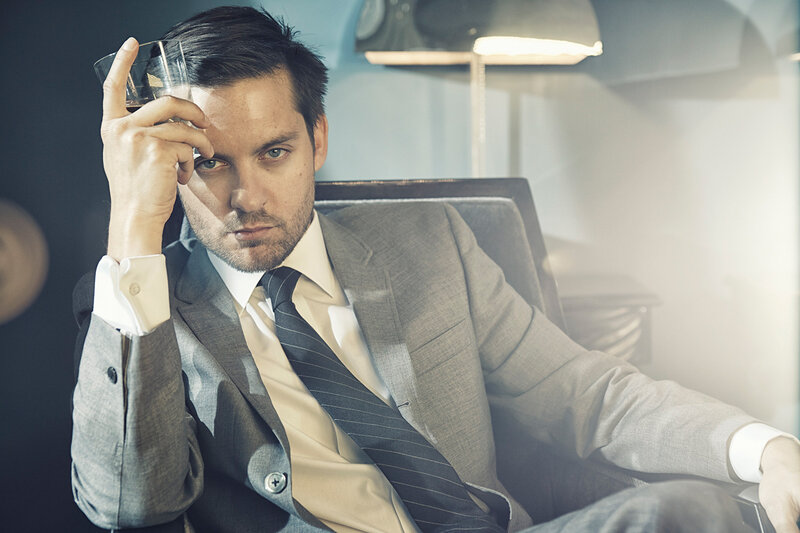 Man in Suit Holding Glass — Gray