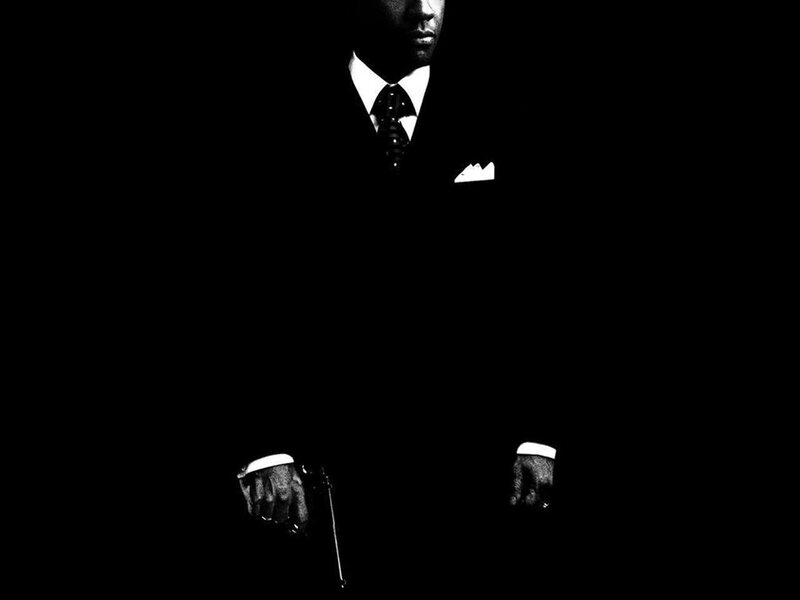 man in suit holding gun
