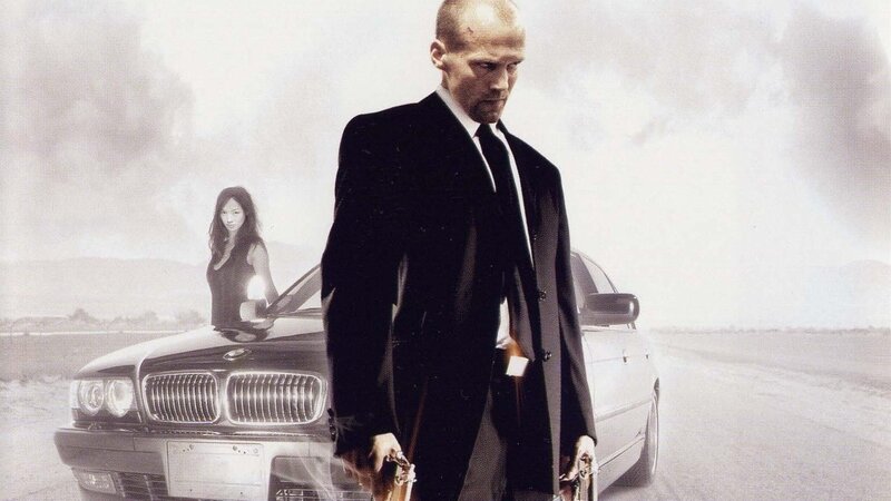 Man in Suit Holding Guns — Black