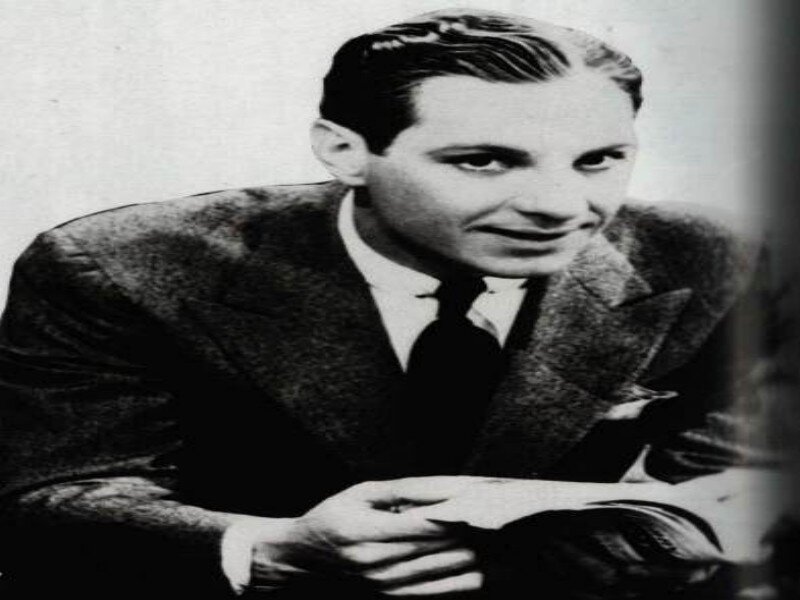 Man in Suit Holding Paper