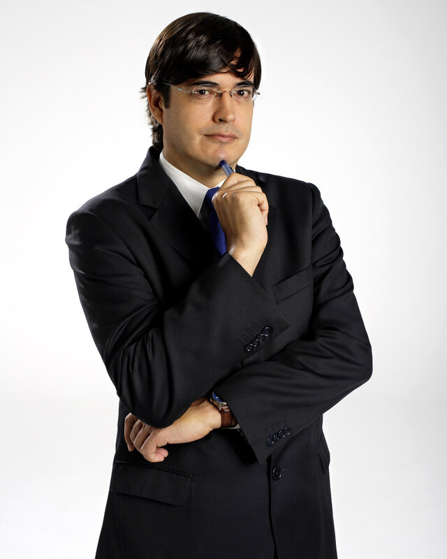 man in suit holding pen