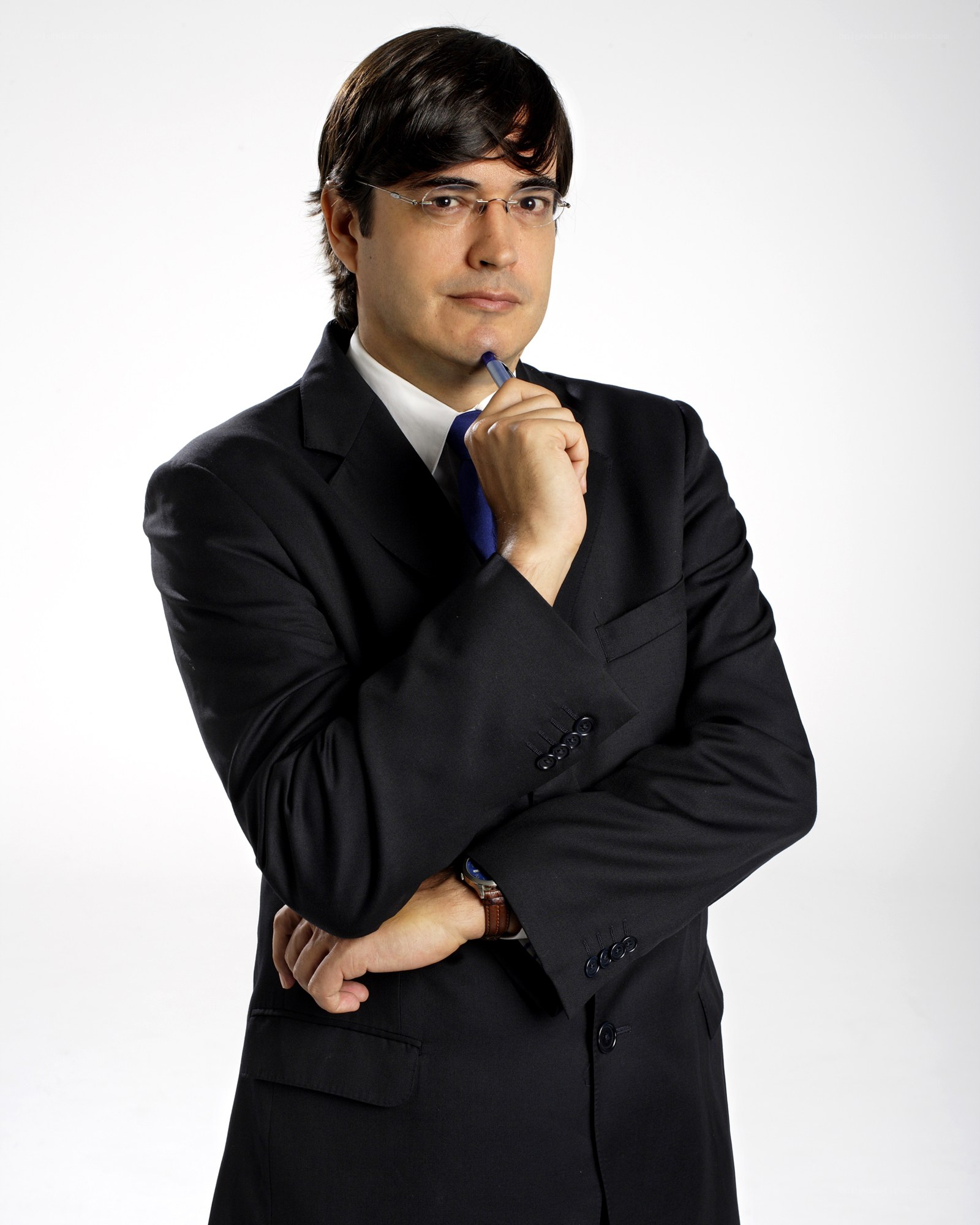 man in suit holding pen