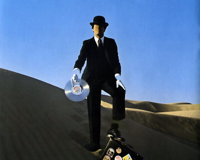 Man in suit holding record