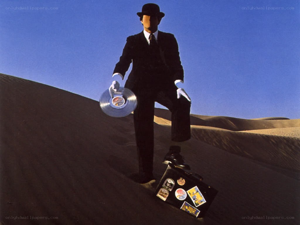 man in suit holding record