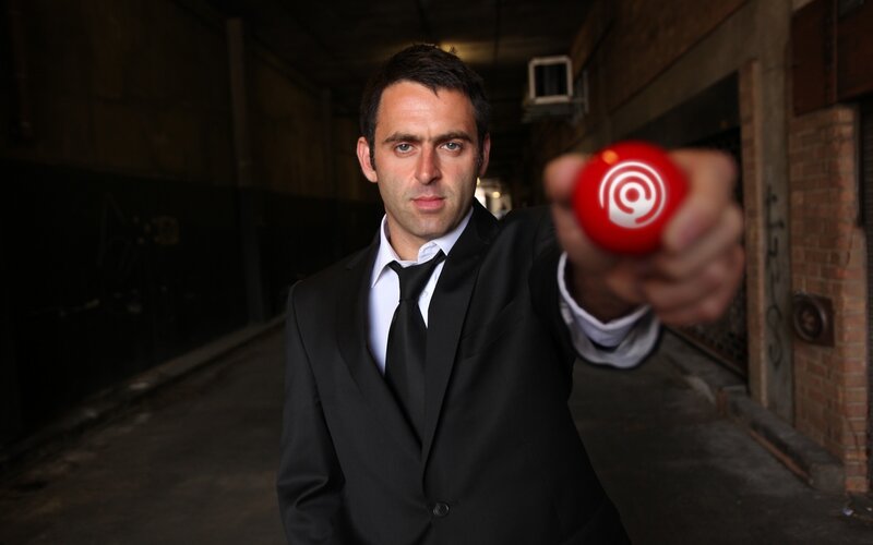 Man in suit holding red ball