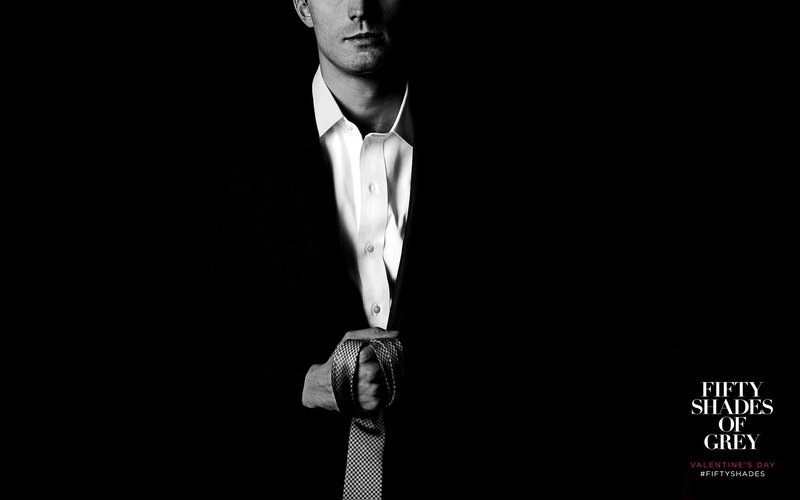 Man in Suit Holding Tie — Black, Dramatic