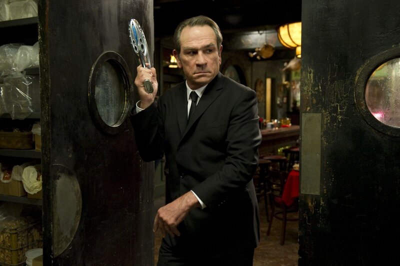 Man in suit holding tool