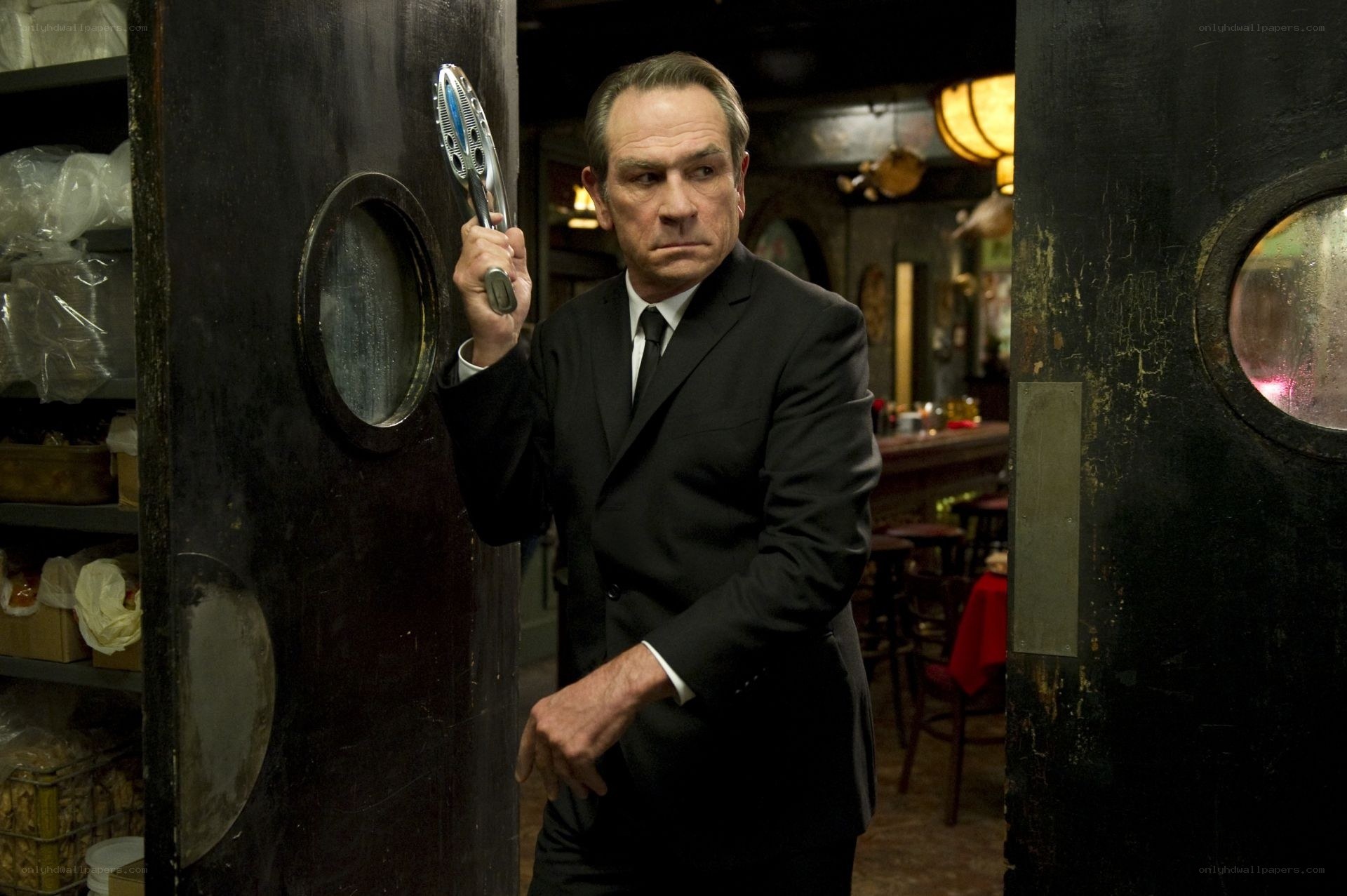 Man in suit holding tool