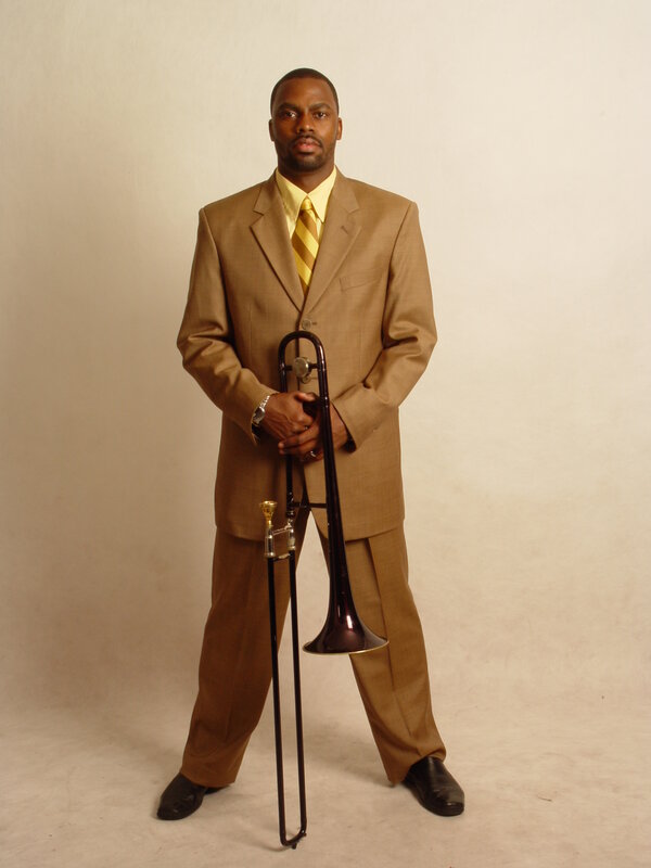 Man in suit holding trombone