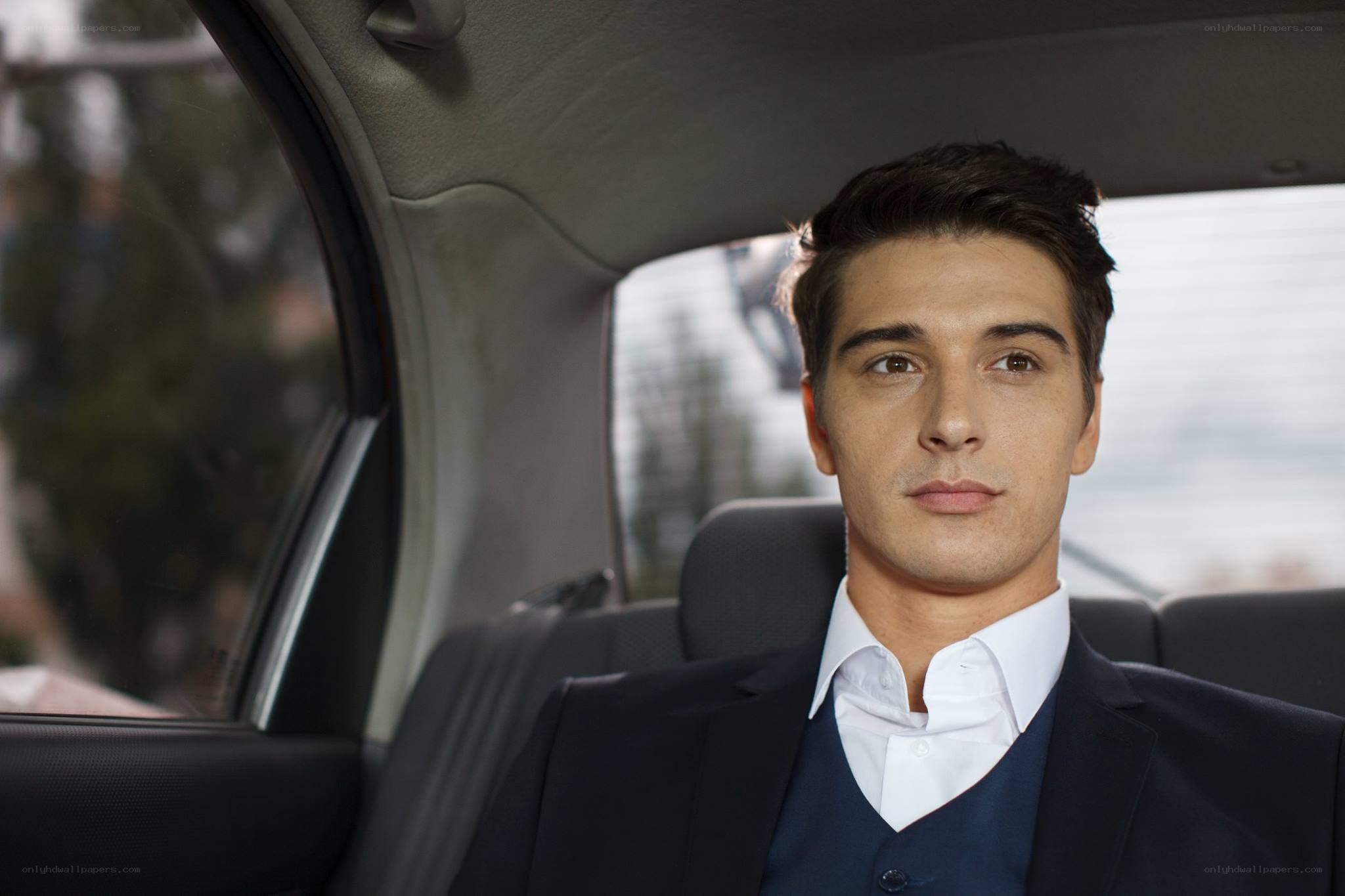man in suit in car