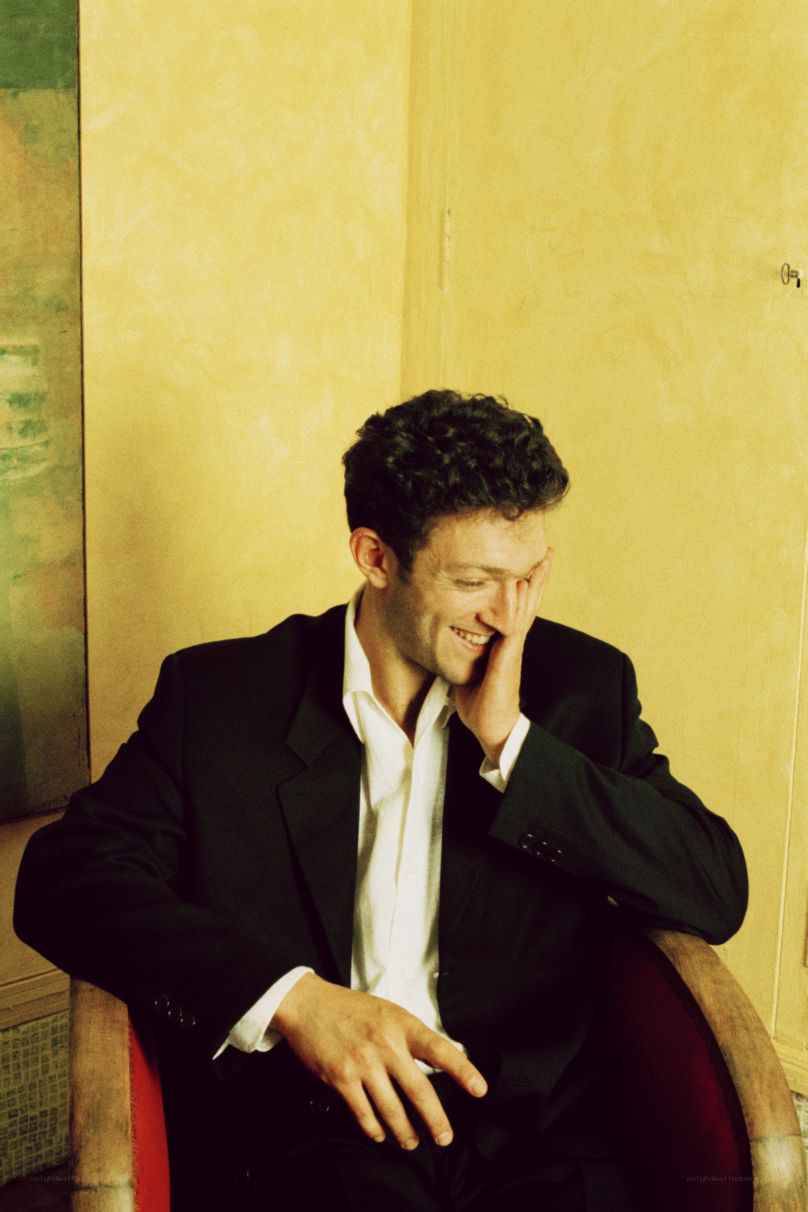 man in suit laughing