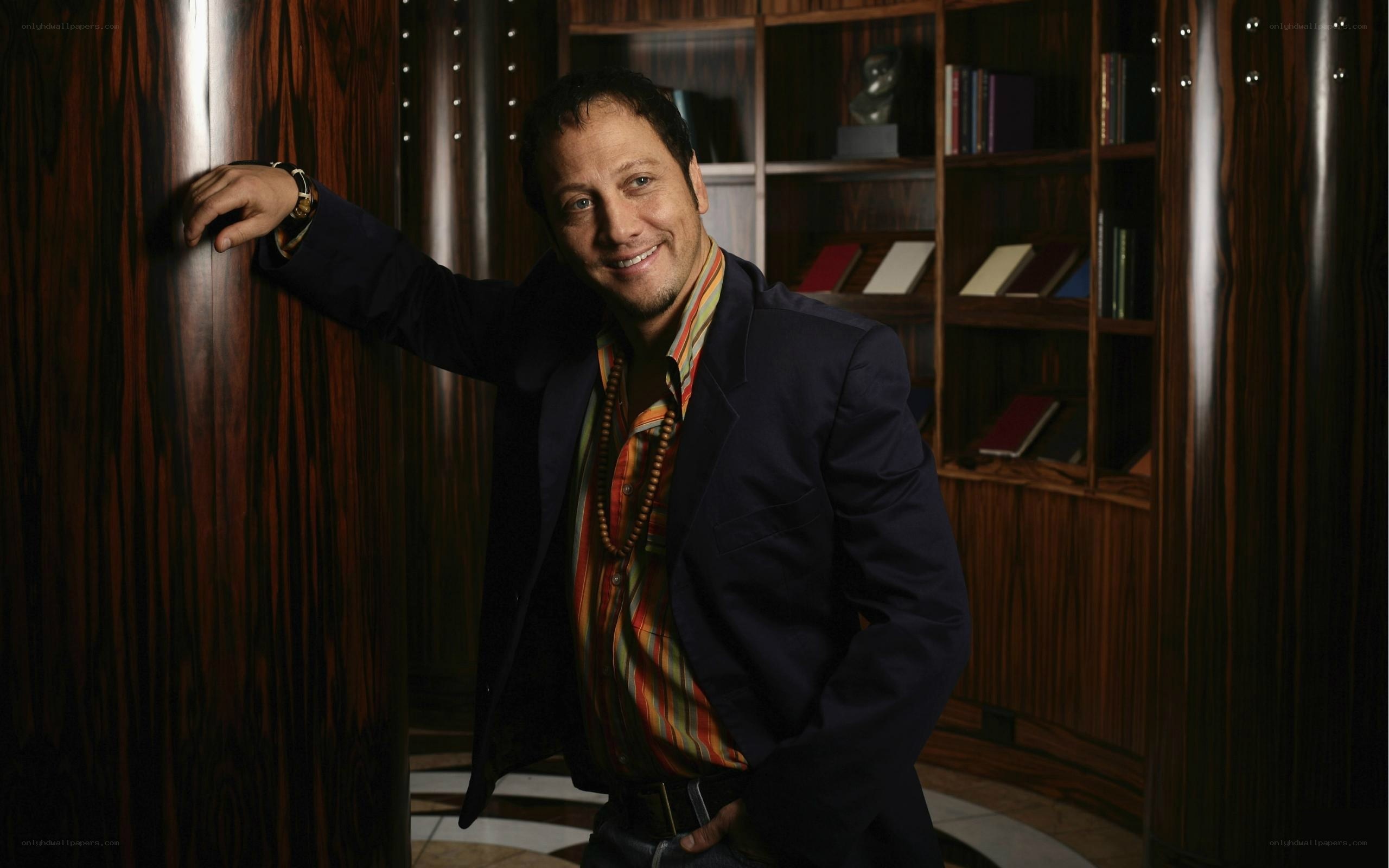 man in suit leaning against wall
