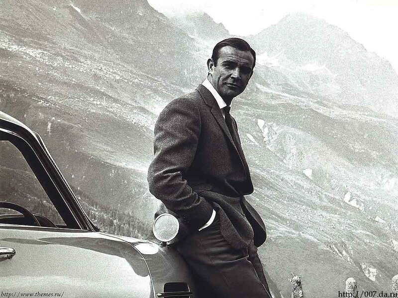 Man in Suit Leaning — Black, Dramatic, Photograph