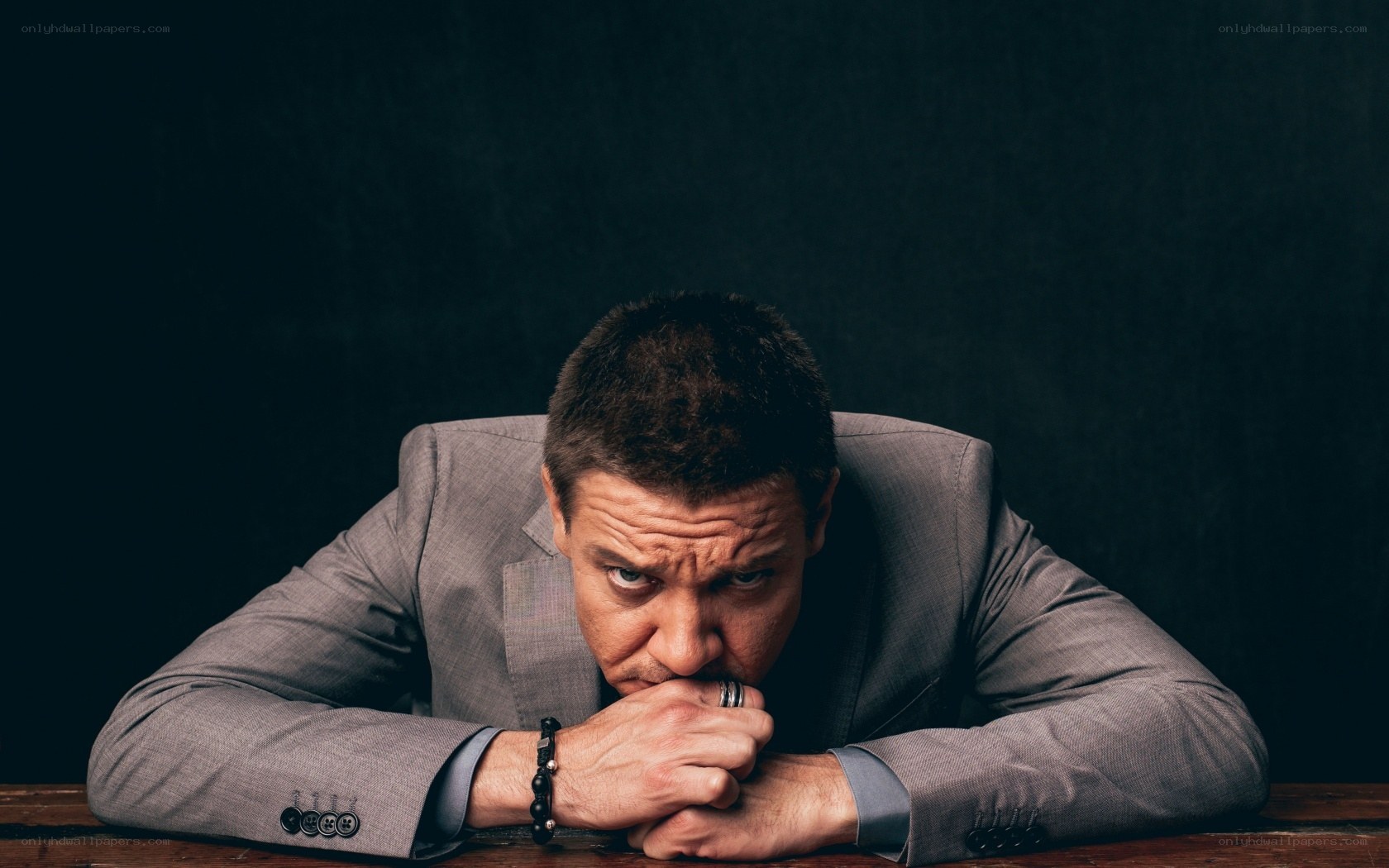 man in suit leaning forward