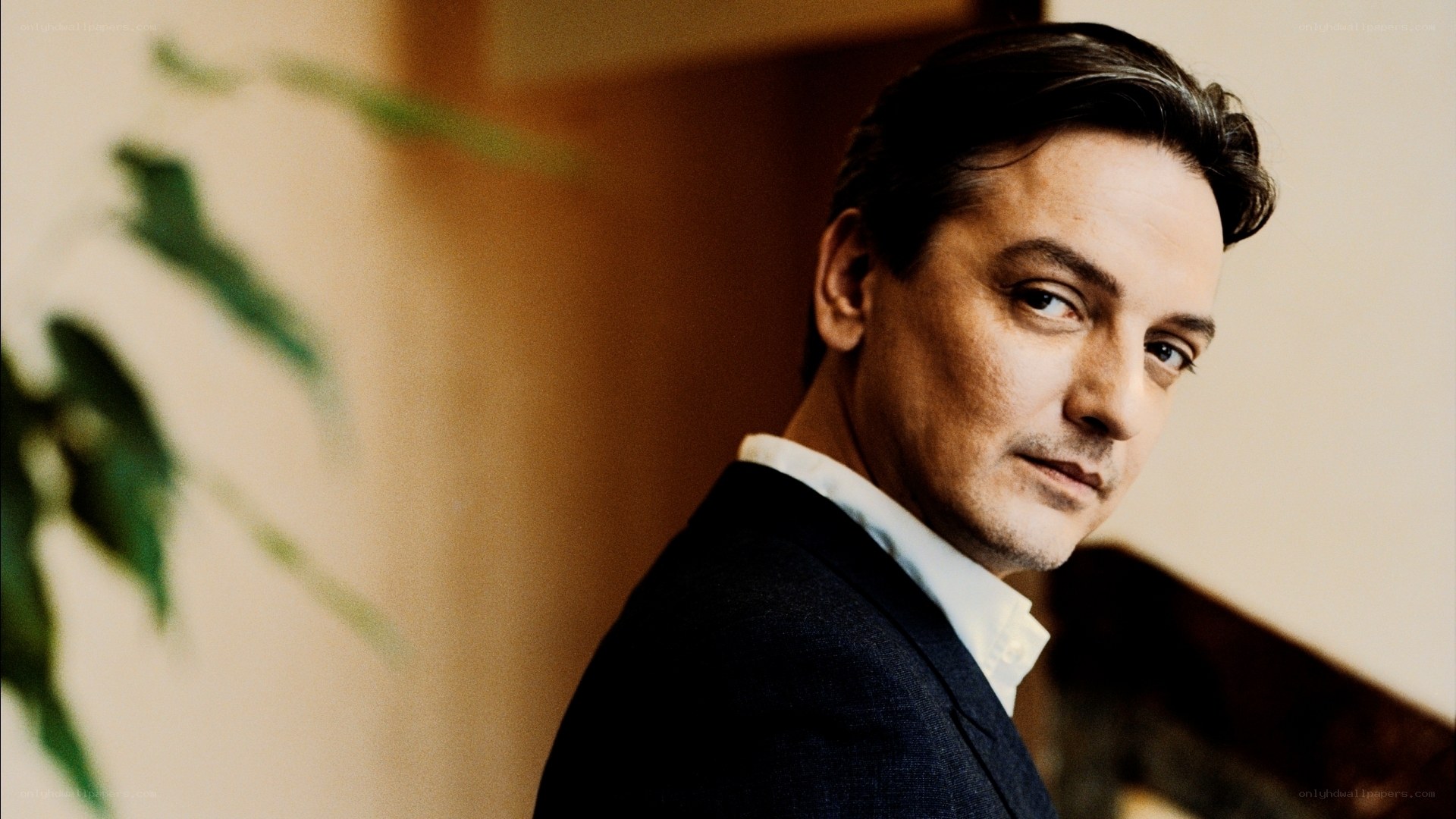 man in suit looking over shoulder