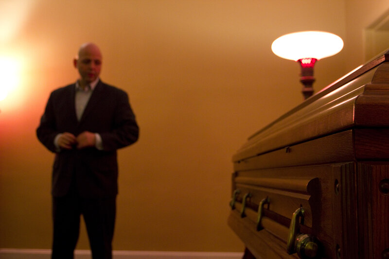 Man in Suit Near Coffin