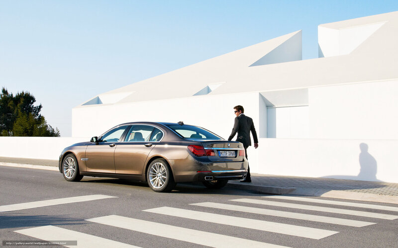 Man in suit near luxury car