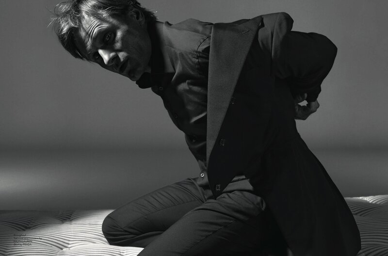 man in suit on bed