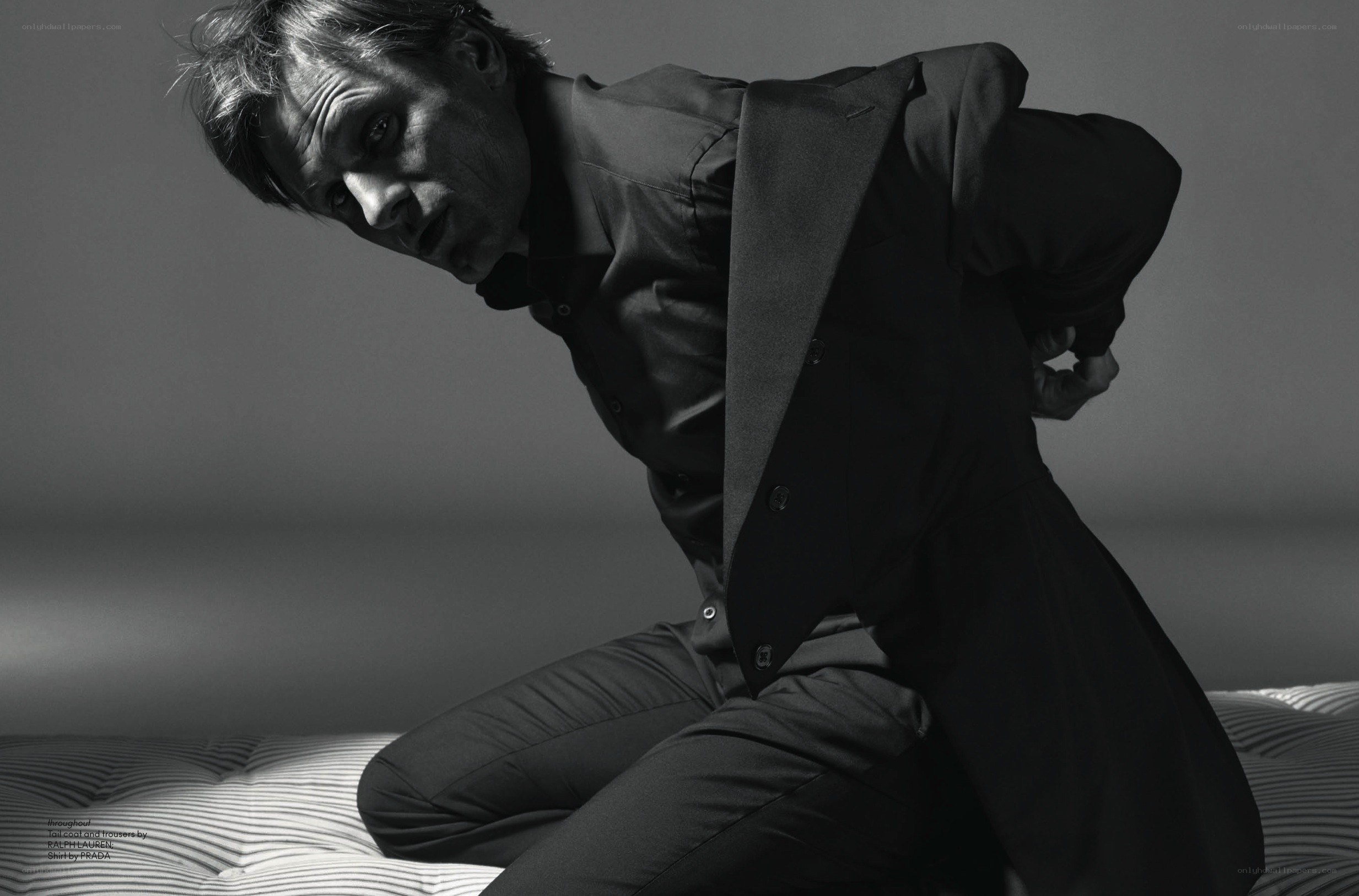 man in suit on bed