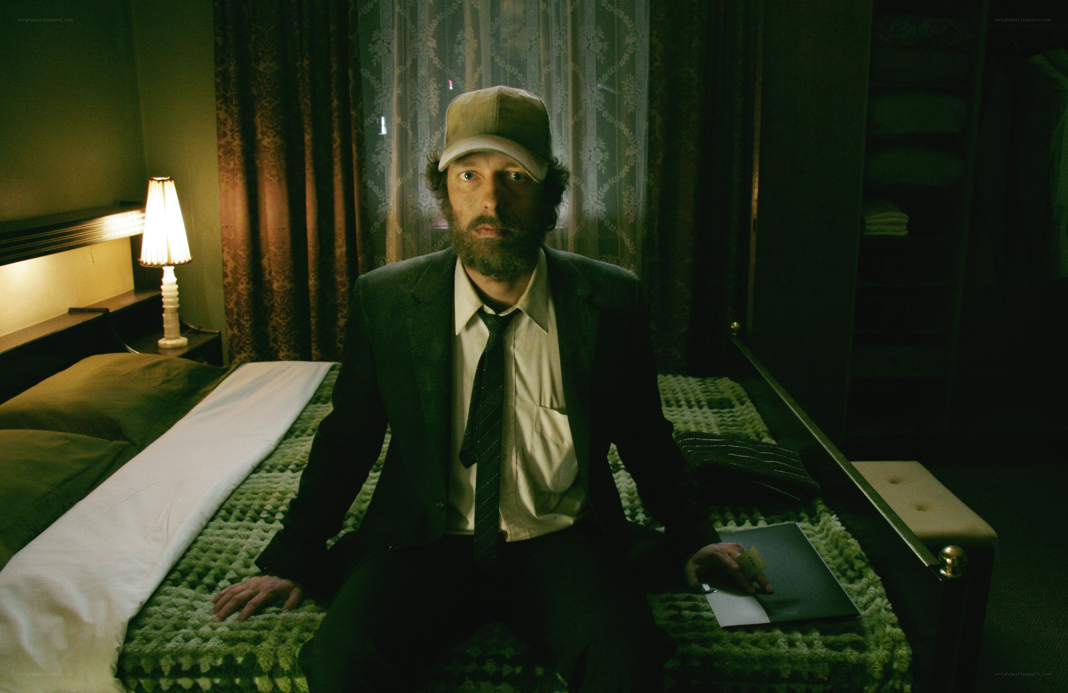 man in suit on bed