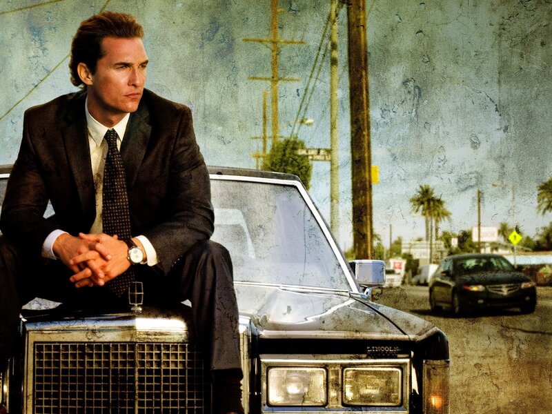 man in suit on car hood