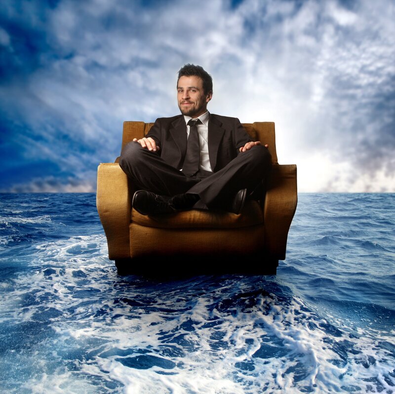 man in suit on chair at sea