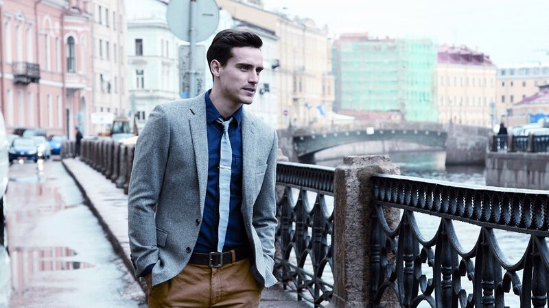 Man in suit on city bridge