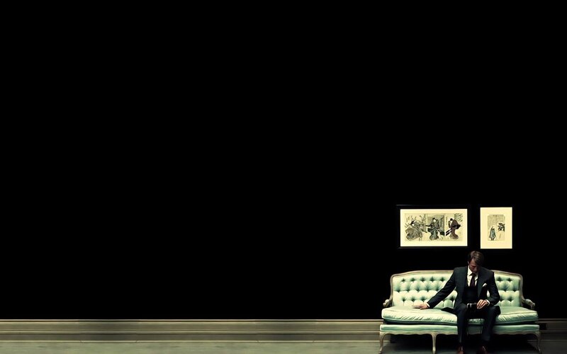 Man in Suit on Couch — Black, Dramatic, Photograph
