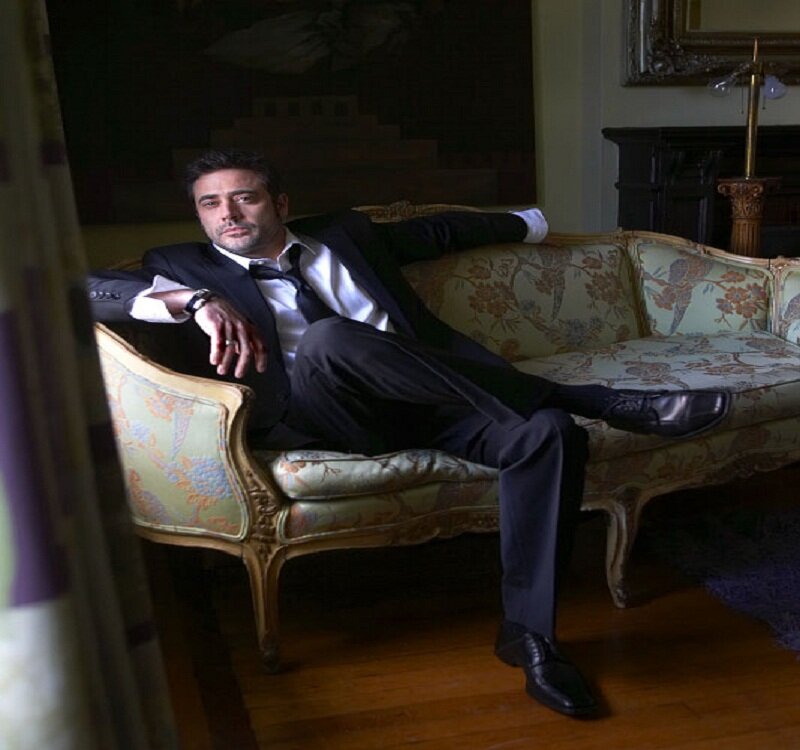 Man in Suit on Couch — Black, Dramatic