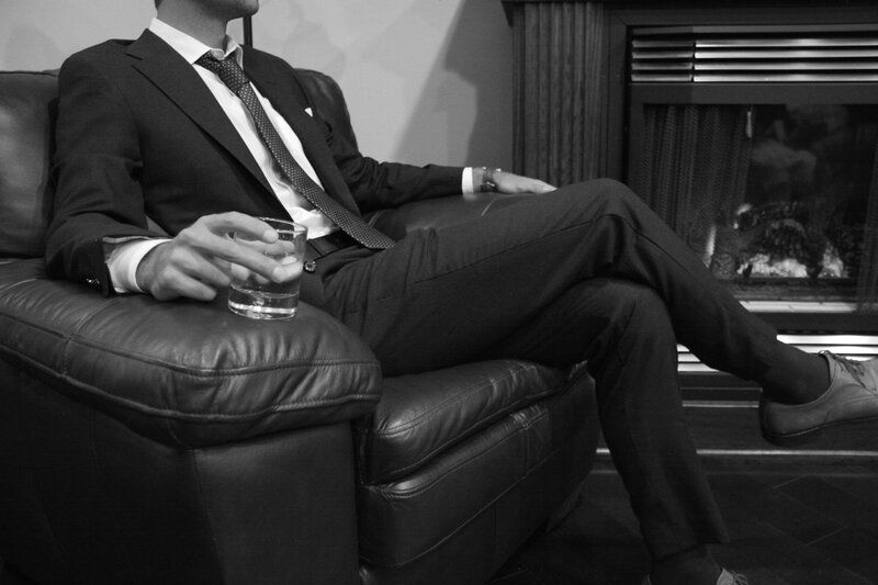 Man in Suit on Couch — Black, Relaxed
