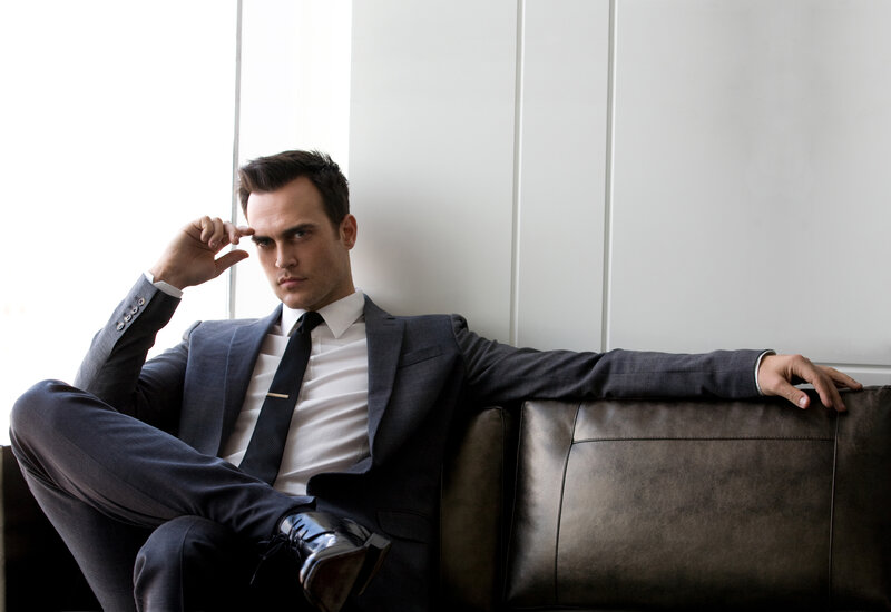 Man in Suit on Couch — Gray