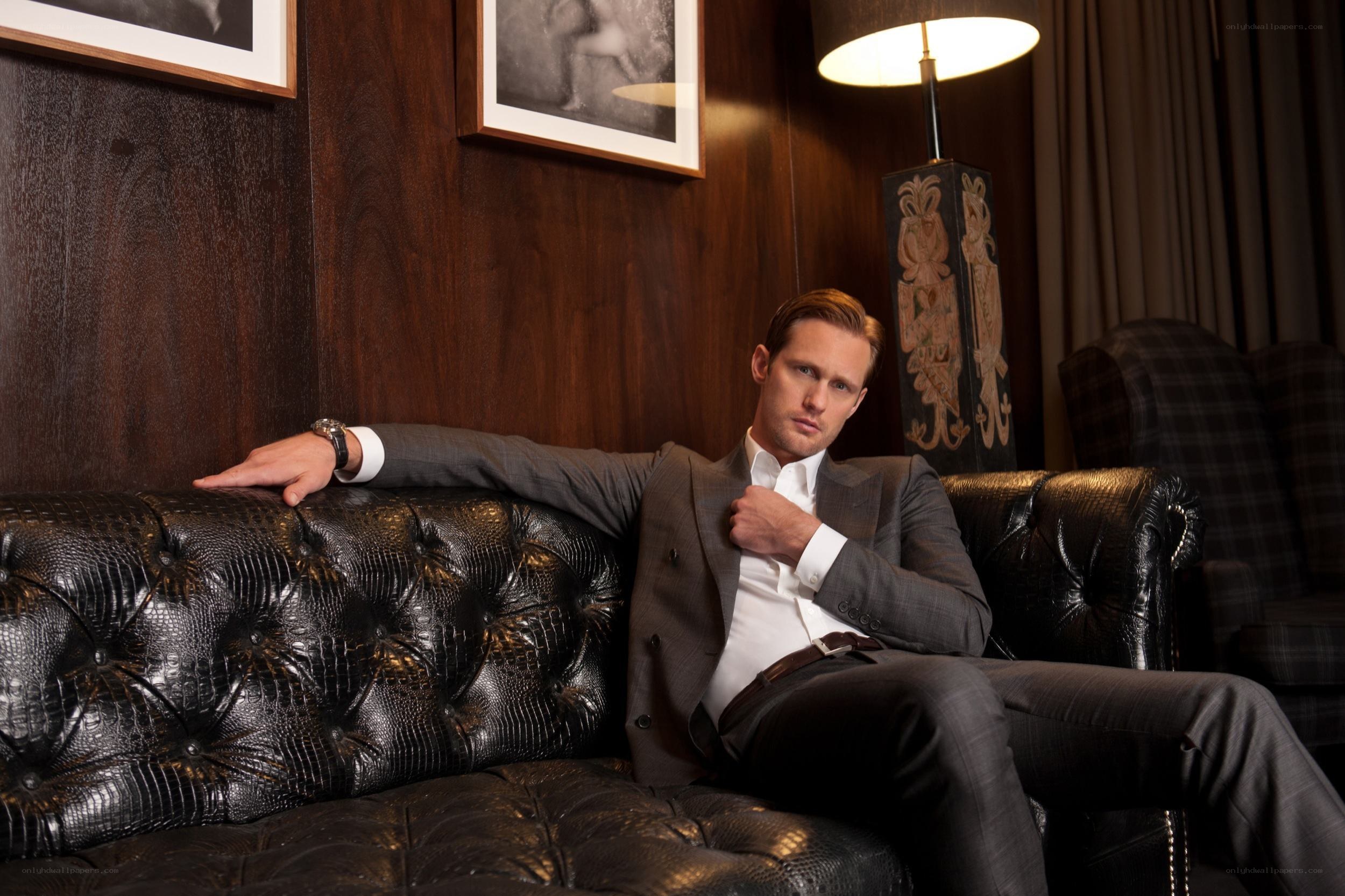 man in suit on leather couch