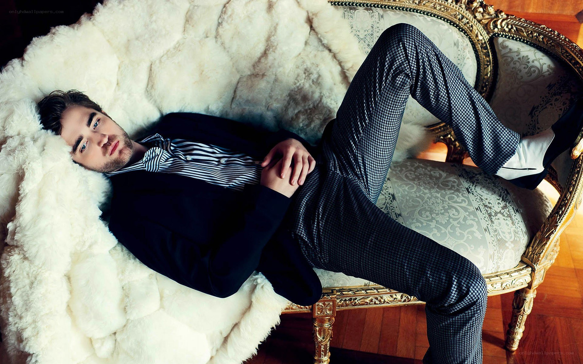 man in suit on ornate couch