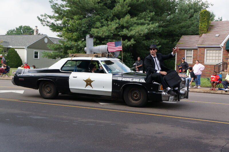 Man in Suit on Police Car