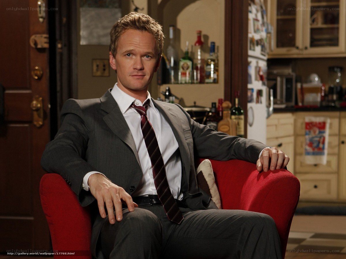 man in suit on red chair