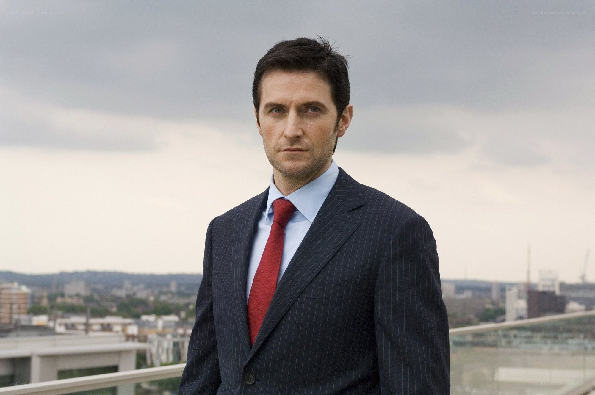 man in suit on rooftop