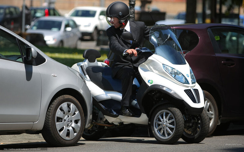 Man in suit on scooter