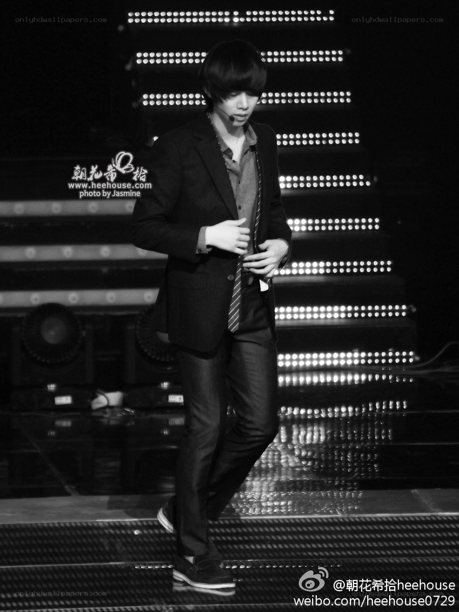 man in suit on stage